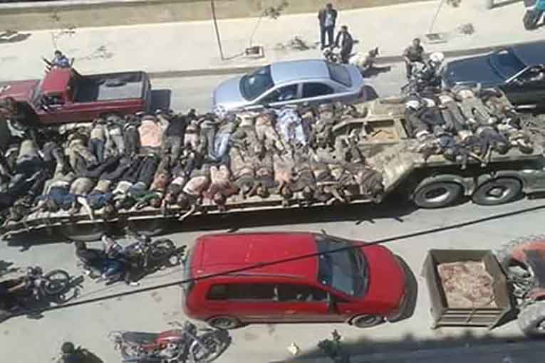 گرداندن اجساد جنگی در خیابانهای شهر توسط «ی.پ.گ» گرداندن اجساد جنگی در خیابانهای شهر توسط «ی.پ.گ»